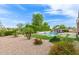 Landscaped backyard with pool, desert plants, and rock ground cover. Ready for summer fun at 3400 S Whetstone Pl, Chandler, AZ 85286
