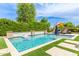 Beautiful backyard features a pool with a lush, green hedge. Perfect for summer fun at 3400 S Whetstone Pl, Chandler, AZ 85286
