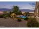 Lush backyard with a sparkling pool, mature palm trees, manicured greenery, and inviting lounge area at 3400 S Whetstone Pl, Chandler, AZ 85286