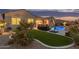 Beautifully landscaped backyard features artificial turf, a cozy patio area, and a sparkling pool at 3400 S Whetstone Pl, Chandler, AZ 85286