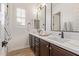 Stylish bathroom with double sinks, modern fixtures, and a bright window with shutters at 3400 S Whetstone Pl, Chandler, AZ 85286
