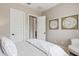 Relaxing bedroom featuring a white chair, neutral walls, and stylish framed decor at 3400 S Whetstone Pl, Chandler, AZ 85286
