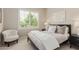Serene bedroom with a shuttered window, chair, black bed frame, and neutral decor at 3400 S Whetstone Pl, Chandler, AZ 85286