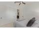 Bright bedroom featuring a ceiling fan, white walls, and a closet with sliding doors at 3400 S Whetstone Pl, Chandler, AZ 85286