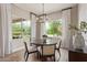 Bright breakfast nook with round table, seating for four, and large windows with backyard views at 3400 S Whetstone Pl, Chandler, AZ 85286