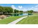 Picturesque community lake with green lawns, a walking path, and tranquil views, creating a serene environment at 3400 S Whetstone Pl, Chandler, AZ 85286