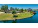 Community park with a splash pad, grassy areas, and covered seating areas, ideal for recreation and Gathering fun at 3400 S Whetstone Pl, Chandler, AZ 85286