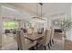 Elegant dining room featuring a rectangular chandelier, seating for six, and an open floor plan at 3400 S Whetstone Pl, Chandler, AZ 85286