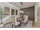 Elegant dining room with a wood table, contemporary lighting, and decorative mirrors at 3400 S Whetstone Pl, Chandler, AZ 85286