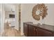 Elegant entryway featuring a decorative mirror above a wood cabinet, adjacent to a living room at 3400 S Whetstone Pl, Chandler, AZ 85286