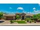 Charming exterior view of a home featuring a landscaped front yard, stone accents, and a two-car garage at 3400 S Whetstone Pl, Chandler, AZ 85286