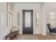 Bright foyer with hardwood floors, stylish decor, and a decorative front door at 3400 S Whetstone Pl, Chandler, AZ 85286