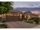 Single-Gathering home showcasing a brick driveway, an attached two-car garage, and well-maintained landscaping at 3400 S Whetstone Pl, Chandler, AZ 85286