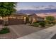 Single-Gathering home showcasing a brick driveway, an attached two-car garage, and beautifully maintained landscaping at 3400 S Whetstone Pl, Chandler, AZ 85286