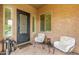 Cozy front porch with seating, a decorative door, and neutral tones at 3400 S Whetstone Pl, Chandler, AZ 85286