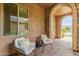 Inviting front porch featuring stone accents, comfortable seating and lush plants at 3400 S Whetstone Pl, Chandler, AZ 85286