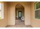 Charming front porch with seating, stone archway, and a stylish front door at 3400 S Whetstone Pl, Chandler, AZ 85286