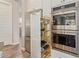 Modern kitchen featuring stainless steel appliances, pull-out shelves, and custom cabinets at 3400 S Whetstone Pl, Chandler, AZ 85286