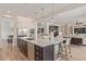 Large kitchen island with a sink, seating, and ample counter space for food preparation and entertaining at 3400 S Whetstone Pl, Chandler, AZ 85286