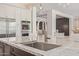 Up close, kitchen island with large sink and faucet, plus seating at 3400 S Whetstone Pl, Chandler, AZ 85286