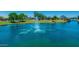 Beautiful lake featuring a central fountain, surrounded by green spaces and community amenities, enhancing the scenery at 3400 S Whetstone Pl, Chandler, AZ 85286