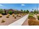A walking path is lined with desert landscaping and small trees, creating a peaceful and inviting outdoor space at 3400 S Whetstone Pl, Chandler, AZ 85286