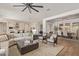 Open-concept living room with cozy seating, wood floors, and a modern kitchen at 3400 S Whetstone Pl, Chandler, AZ 85286
