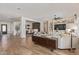 Spacious living room with built-in shelves, wood floors, and views of dining room and entry at 3400 S Whetstone Pl, Chandler, AZ 85286