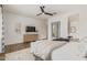 Bright main bedroom featuring hardwood floors, a dresser, a modern mirror, and a comfortable bed at 3400 S Whetstone Pl, Chandler, AZ 85286