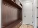 Inviting mudroom features dark wood built-ins, storage cabinets, hooks, and a bench for added convenience at 3400 S Whetstone Pl, Chandler, AZ 85286