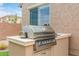 Built-in outdoor grill on a patio, perfect for summer barbecues and entertaining guests at 3400 S Whetstone Pl, Chandler, AZ 85286