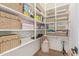 Organized pantry with white shelving units filled with baskets, boxes, and other household essentials at 3400 S Whetstone Pl, Chandler, AZ 85286