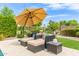 Cozy patio area with comfortable seating and a shaded umbrella, ideal for relaxing and enjoying the outdoors at 3400 S Whetstone Pl, Chandler, AZ 85286