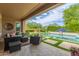 Spacious covered patio with outdoor seating, perfect for enjoying the pool and landscaped yard at 3400 S Whetstone Pl, Chandler, AZ 85286