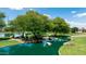 Picturesque pond with mature trees, bridge, and rocks, offering a serene community amenity at 3400 S Whetstone Pl, Chandler, AZ 85286