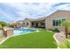 Inviting backyard with pool, patio seating, and lush landscaping, perfect for outdoor entertaining and relaxation at 3400 S Whetstone Pl, Chandler, AZ 85286