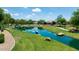Scenic view of waterway with green landscaping, homes, and a paved walking path at 3400 S Whetstone Pl, Chandler, AZ 85286
