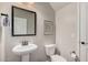 Powder room features a pedestal sink, modern mirror, and neutral tones at 3900 E Baseline Rd # 137, Phoenix, AZ 85042