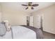 Inviting bedroom with a large bed, neutral decor, ceiling fan, and attached bathroom at 3900 E Baseline Rd # 137, Phoenix, AZ 85042