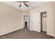 Neutral bedroom with a ceiling fan, closet, and doorway to another room at 3900 E Baseline Rd # 137, Phoenix, AZ 85042