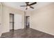 Bedroom features a ceiling fan, closet, and a view into the bathroom at 3900 E Baseline Rd # 137, Phoenix, AZ 85042