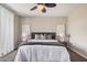 Comfortable bedroom with a ceiling fan, large bed, stylish decor, and neutral tones at 3900 E Baseline Rd # 137, Phoenix, AZ 85042