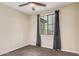 Cozy bedroom with a ceiling fan, window, and neutral carpet at 3900 E Baseline Rd # 137, Phoenix, AZ 85042