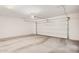 Empty two car garage with opener and blank white walls at 3900 E Baseline Rd # 137, Phoenix, AZ 85042