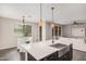 Open-concept kitchen with a stainless steel sink, quartz counters, and adjoining dining and living areas at 3900 E Baseline Rd # 137, Phoenix, AZ 85042