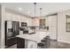 Open kitchen featuring white cabinets, stainless steel appliances, a large island, and modern fixtures at 3900 E Baseline Rd # 137, Phoenix, AZ 85042