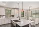 Beautiful kitchen featuring a large island with a sink, stylish cabinets, and contemporary lighting at 3900 E Baseline Rd # 137, Phoenix, AZ 85042
