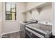 Laundry room with stainless steel washer and dryer set and window at 3900 E Baseline Rd # 137, Phoenix, AZ 85042