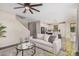 Comfortable living room showcasing a stylish sofa, a modern fan, and an open floor plan at 3900 E Baseline Rd # 137, Phoenix, AZ 85042