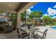 Covered patio features seating, a view to the pool, and manicured landscaping at 3900 E Baseline Rd # 137, Phoenix, AZ 85042